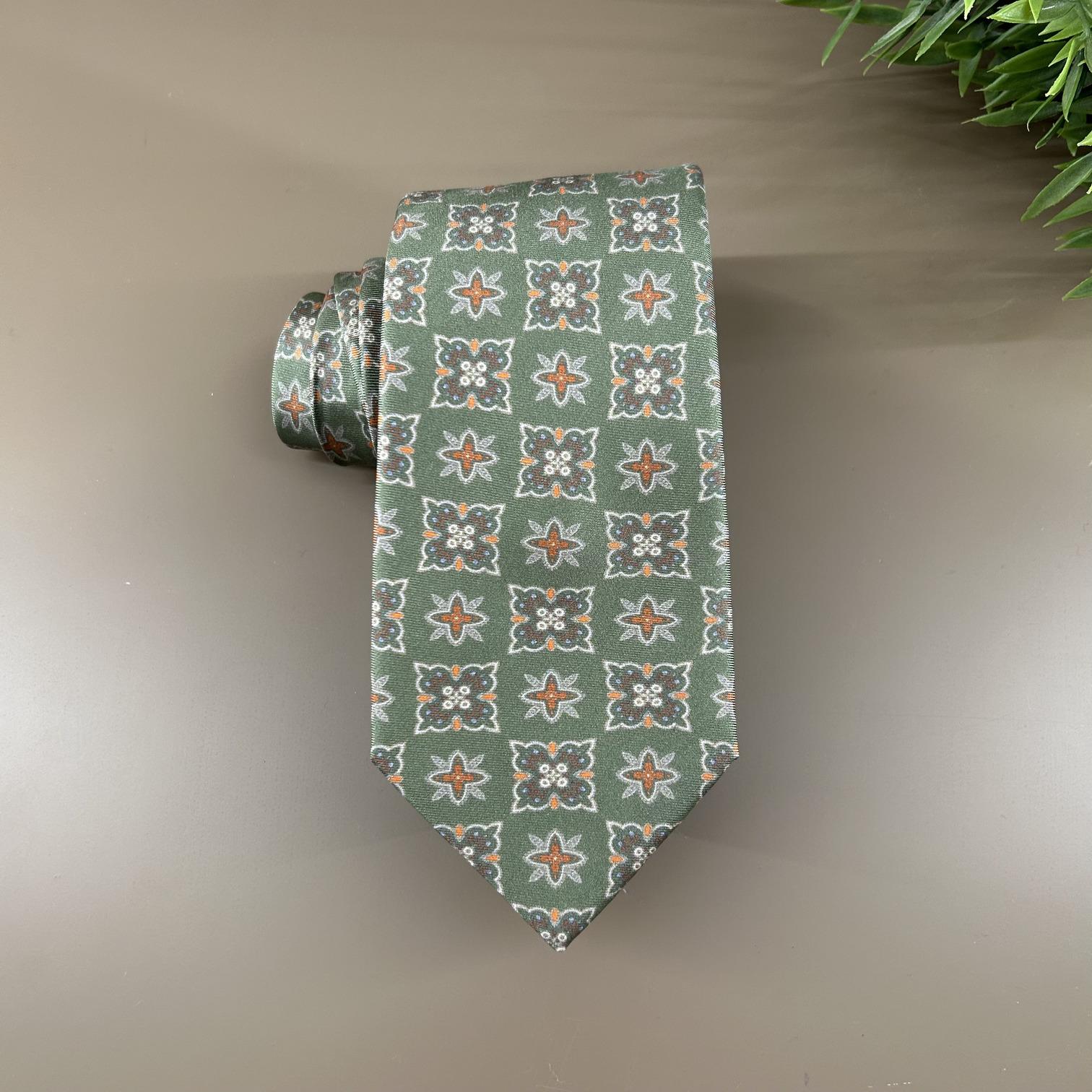 Olive green tie with flower/stars in orange tones