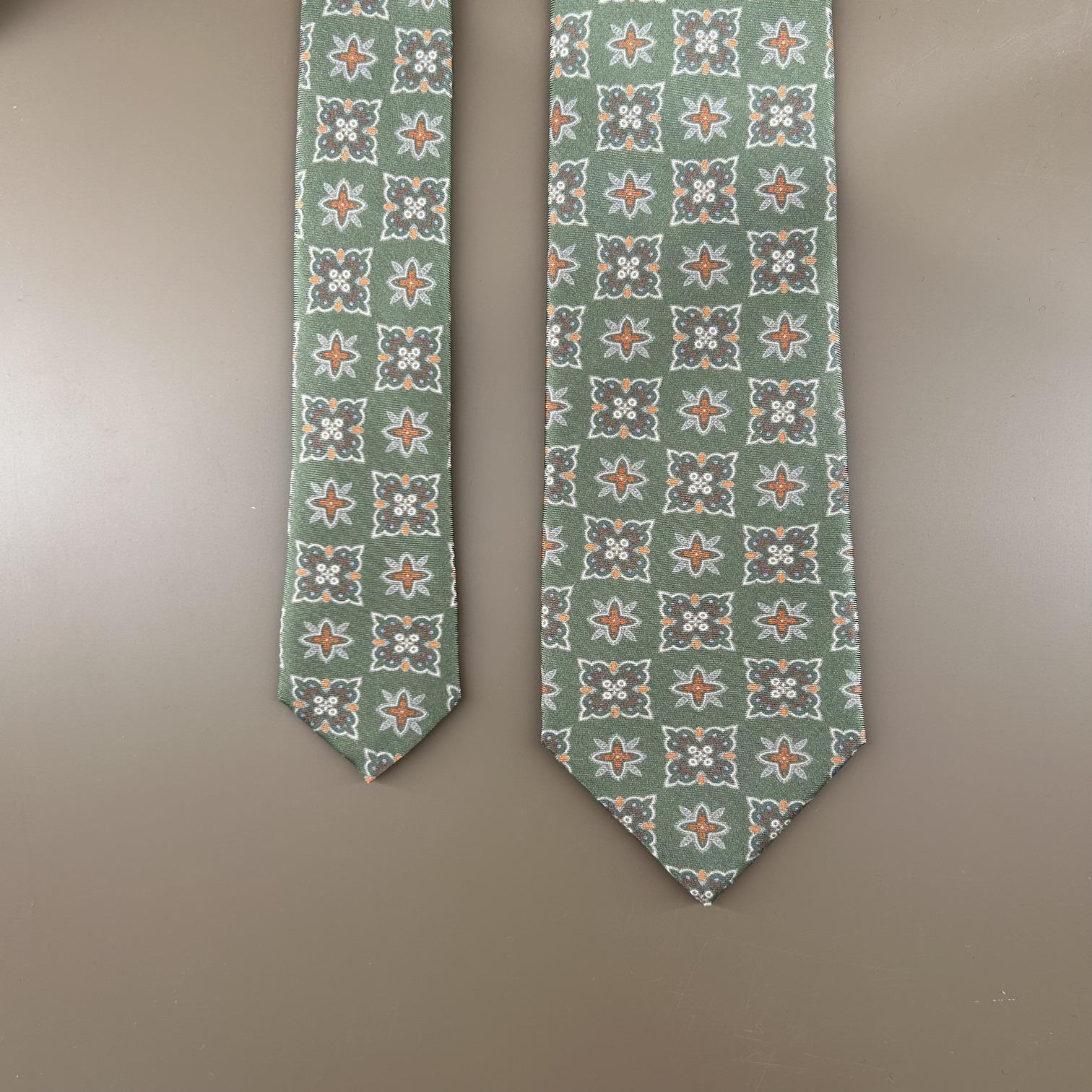 Olive green tie with flower/stars in orange tones