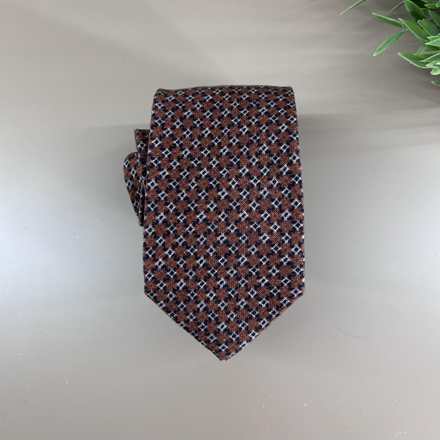 Terracotta wool tie with small geometric patterns