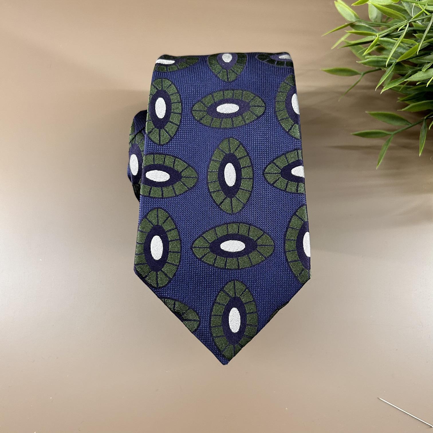 Blue jacquard tie with green and silver oval print
