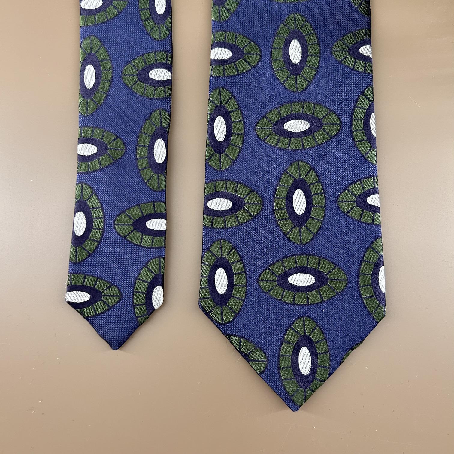 Blue jacquard tie with green and silver oval print